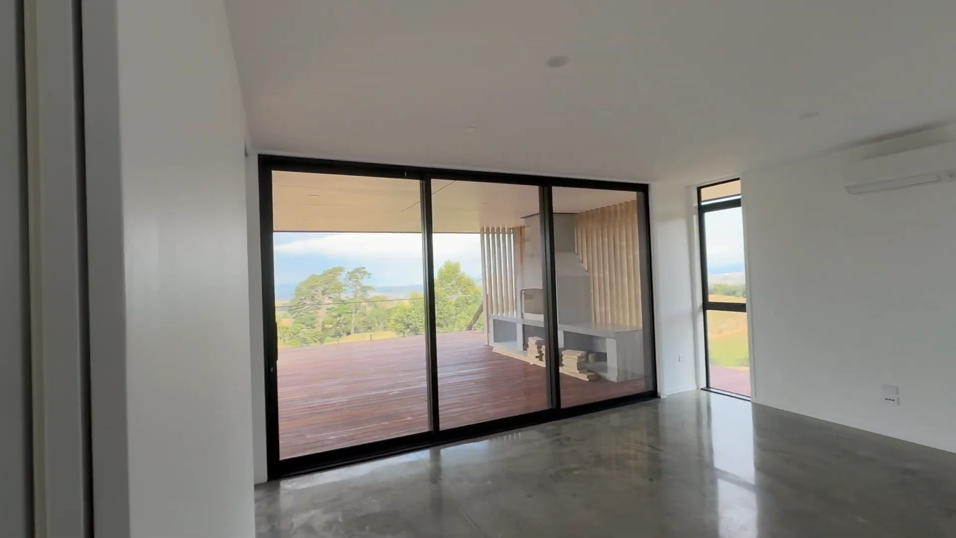 Painted white walls and ceiling beside the glazed doors during interior finishing at Pirongia